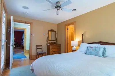 a bedroom with a bed and a ceiling fan at Emilyville Inn in Campbellford