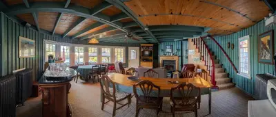 a dining room with a table and chairs at Windswept on the Trent in Campbellford
