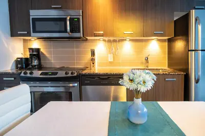 a kitchen with a vase of flowers on a table at Urban Skyline in Toronto
