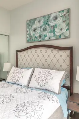 a bedroom with a bed and a painting on the wall at Urban Skyline in Toronto