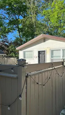 a house on top of a wooden fence at Wasaga Beach Cottage 2 in Wasaga Beach