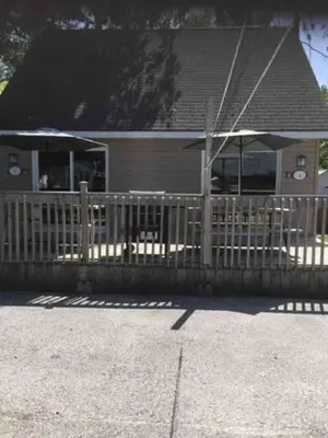 a wooden fence in front of a house at Wasaga Beach Loft 4 in Wasaga Beach