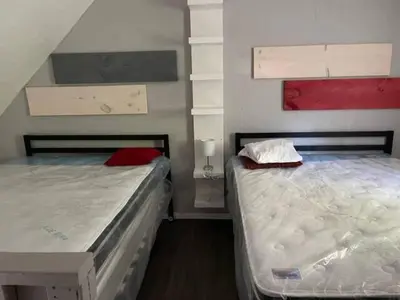 two beds sitting next to each other in a room at Wasaga Beach Loft 4 in Wasaga Beach
