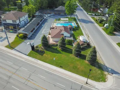 an aerial view of a house with a swimming pool at Beach Club by Beach1 Motel in Wasaga Beach