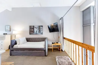 a living room with a bed and a tv at Wintergreen 127 in Blue Mountains