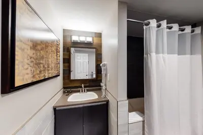 a bathroom with a sink and a shower curtain at Wintergreen 127 in Blue Mountains
