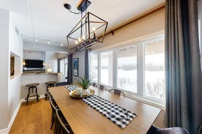 a dining room with a table and a large window at Wintergreen 127 in Blue Mountains