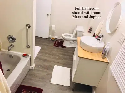 a bathroom with a sink and a toilet at Cheerful residence in Niagara Falls
