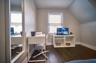 a room with a desk with a computer on it at Hamilton Chic Retreat - Comfy Beds - Garden - Pool in Hamilton