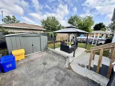 a backyard with an umbrella and a playground at Hamilton Chic Retreat - Comfy Beds - Garden - Pool in Hamilton