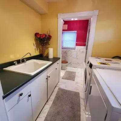a bathroom with a sink and a toilet at Garden 2 Storey House in Niagara Falls