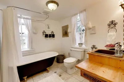 a bathroom with a tub and a toilet and a sink at The Prince Edward County Church, A Unique Escape in Belleville