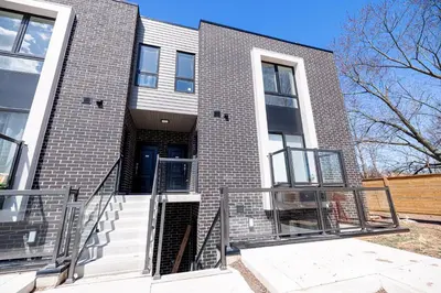 a brick building with stairs in front of it at Luxury & Comfy Apartment, Mins Drive To All Niagara Falls Attraction in Niagara Falls