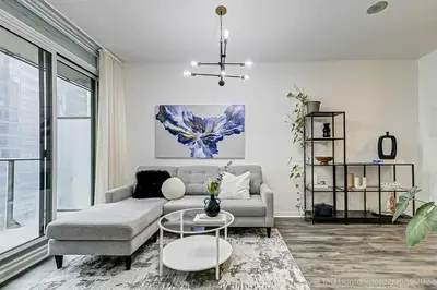 a living room with a couch and a table at Prime Location - Stunning 2-bdrm Condo in Toronto