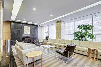 a living room with a couch and a table at Prime Location - Stunning 2-bdrm Condo in Toronto