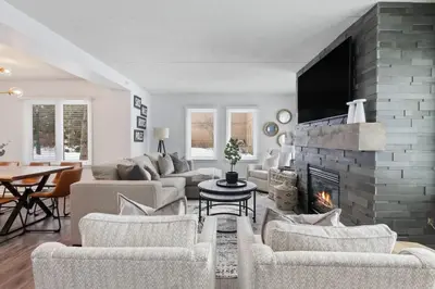 a living room with a couch and a fireplace at Mountain Walk Chalet Across From Blue Mtn Village in Blue Mountains