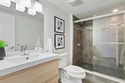 a bathroom with a toilet and a shower and a sink at Mountain Walk Chalet Across From Blue Mtn Village in Blue Mountains