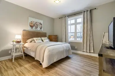 a bedroom with a bed and a window at Contemporary Chalet Steps to Blue Mountain Village in Blue Mountains