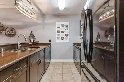 a kitchen with a sink and a refrigerator at Contemporary Chalet Steps to Blue Mountain Village in Blue Mountains