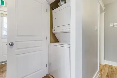 a white kitchen with a washer and dryer at Contemporary Chalet Steps to Blue Mountain Village in Blue Mountains