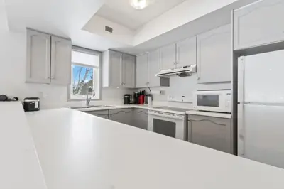 a kitchen with white cabinets and a white counter top at Condo With Blue Mtn Village In Your Backyard in Blue Mountains