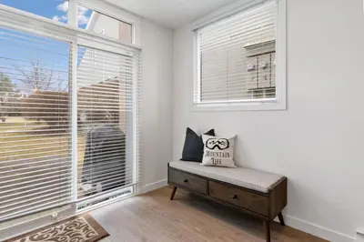 a white room with a bench and a large window at Luxury Blue Mtn Getaway w Indoor Sauna in Blue Mountains
