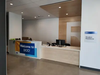 an office with a welcome to dog sign on a counter at Toronto Metropolitan University-Daphne Cockwell Complex Residence in Toronto