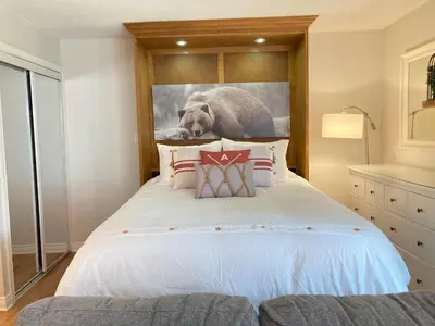 a bedroom with a bed with a picture of an elephant at Modern Mountainside Ski In/Ski Out Studio at Blue in Blue Mountains