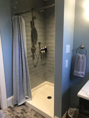 a bathroom with a shower with a shower curtain at Stone's Throw Stratford in Stratford