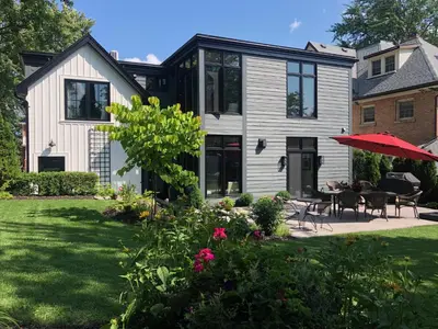 a house with a patio with a table and chairs at Stone's Throw Stratford in Stratford