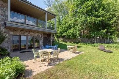 a patio with a table and chairs in a yard at Family Lakeside Oasis in Innisfil