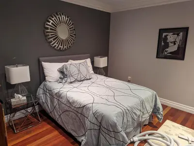 a bedroom with a bed and a mirror on the wall at Family Lakeside Oasis in Innisfil