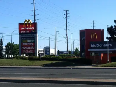 two mcdonalds signs on the side of a street at Home Stay near the Airport in Mississauga