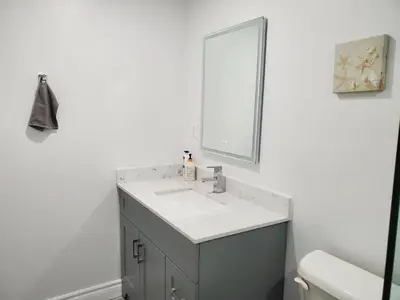 a bathroom with a sink and a mirror at Home Stay near the Airport in Mississauga