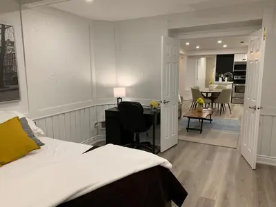a bedroom with a bed and a desk and a dining room at Luxurious and Spacious Apartment with 2 bedrooms and 2 Baths in Mississauga