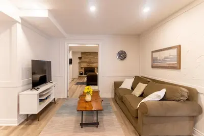 a living room with a couch and a tv at Luxurious and Spacious Apartment with 2 bedrooms and 2 Baths in Mississauga