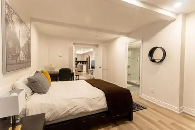 a bedroom with a large bed and a dining room at Luxurious and Spacious Apartment with 2 bedrooms and 2 Baths in Mississauga