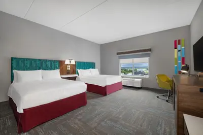 a hotel room with two beds and a television at Hampton Inn Midland, On in Midland