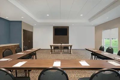 a large room with tables and chairs and a screen at Hampton Inn Midland, On in Midland