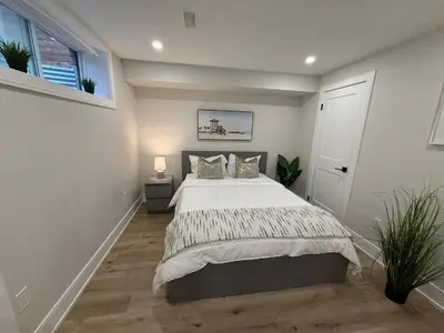 a bedroom with a bed and a window at Modern 1BR - Heart of Queen West in Toronto