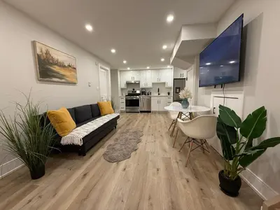 a living room with a couch and a table at Modern 1BR - Heart of Queen West in Toronto