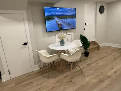 a dining room with a white table and white chairs at Modern 1BR - Heart of Queen West in Toronto