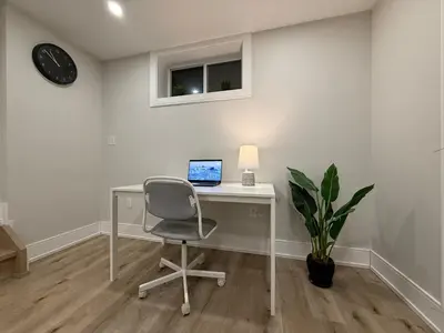 a desk with a chair and a laptop on it at Modern 1BR - Heart of Queen West in Toronto