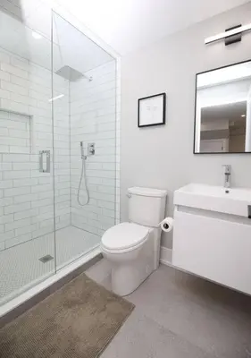 a bathroom with a shower and a toilet and a sink at Modern 1BR - Heart of Queen West in Toronto