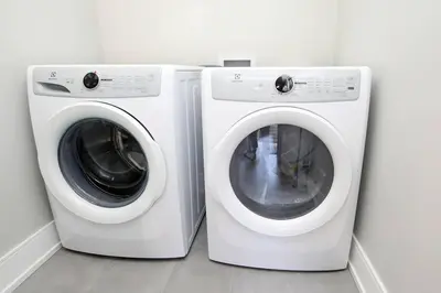 two white washing machines are next to each other at Modern 1BR - Heart of Queen West in Toronto
