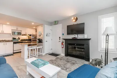 a living room with a fireplace and a kitchen at Blue Heart Mountain Studio Dream Walk to slopes, tennis in Blue Mountains