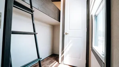 a room with a ladder next to a door at Bellmere Winds Resort in Keene