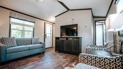 a living room with a couch and a tv at Bellmere Winds Resort in Keene
