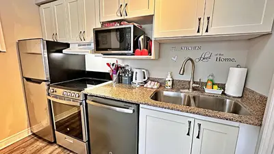 a small kitchen with a sink and a microwave at Freshly Upgraded Cozy Loft @ North Creek Resort in Blue Mountains