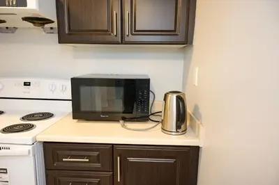 a microwave sitting on top of a kitchen counter at Peace Alcove in Milton